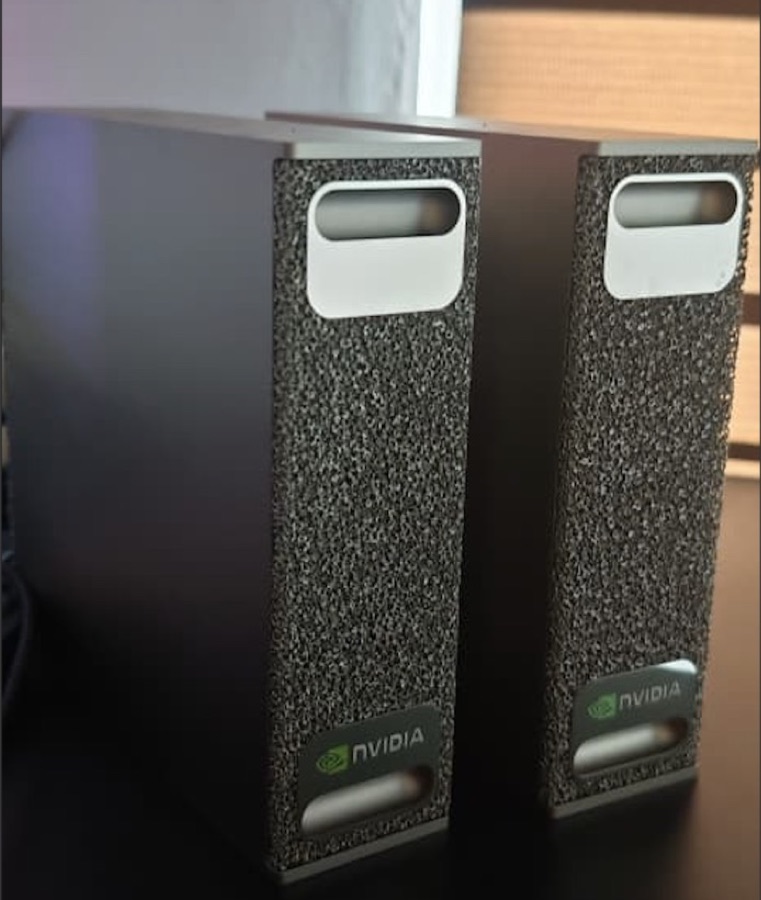 Two NVIDIA DGX Spark units standing side by side on a desk